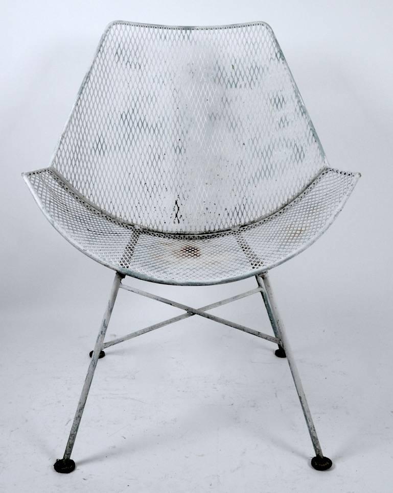 Four chic modernist design metal mesh and wrought iron dining height chairs. Manufacture attributed to Salterini, suitable for outdoor or outdoor use. 
Finish shows wear, normal and consistent with use. Please view the matching table, and other