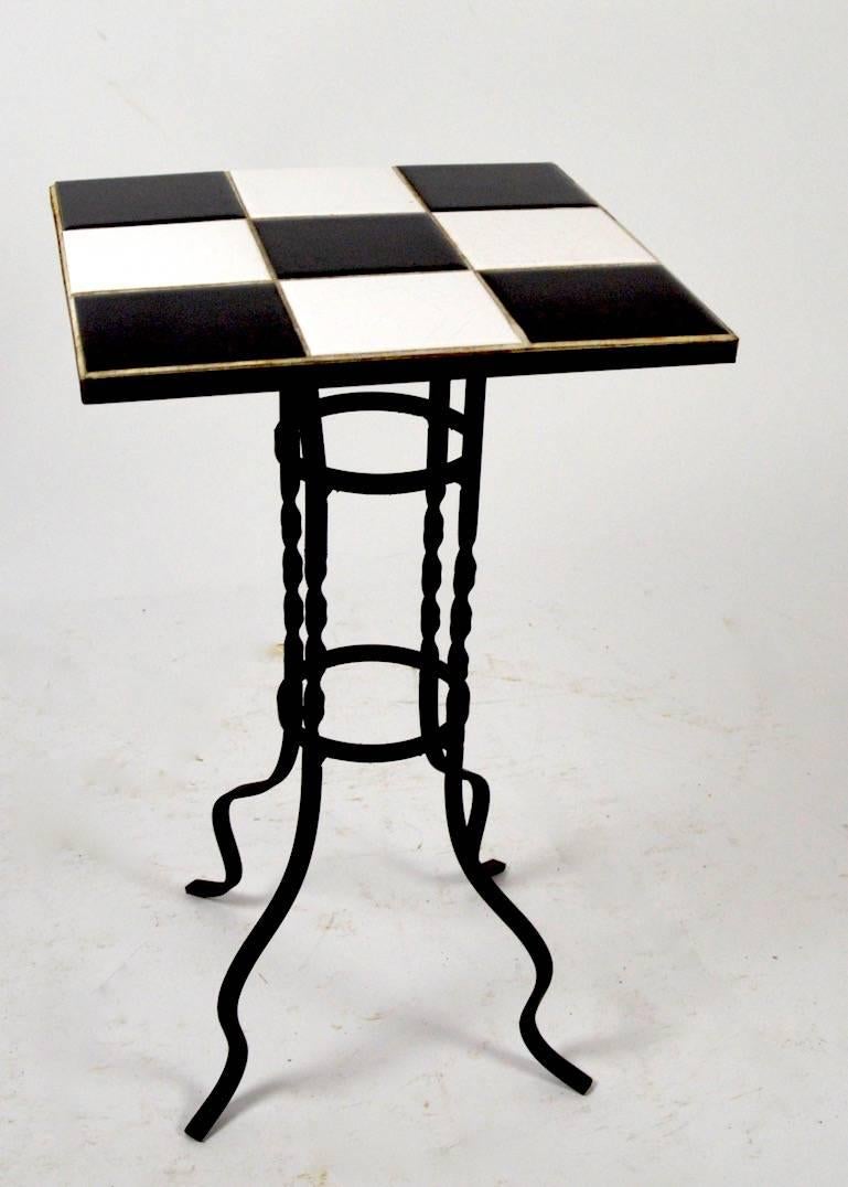 Striking black and white tile-top stand with wrought iron base. Suitable for indoor or outdoor use.