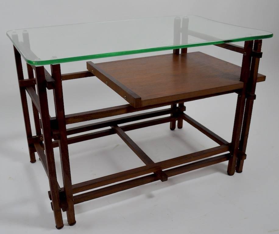Pair of architectural wood and glass tables, after Henning Norgaard, for Komfort. 
 Both are in very good, original condition, showing only minor cosmetic wear, normal and consistent with age. Original shaped plate glass tops rest on squared wood