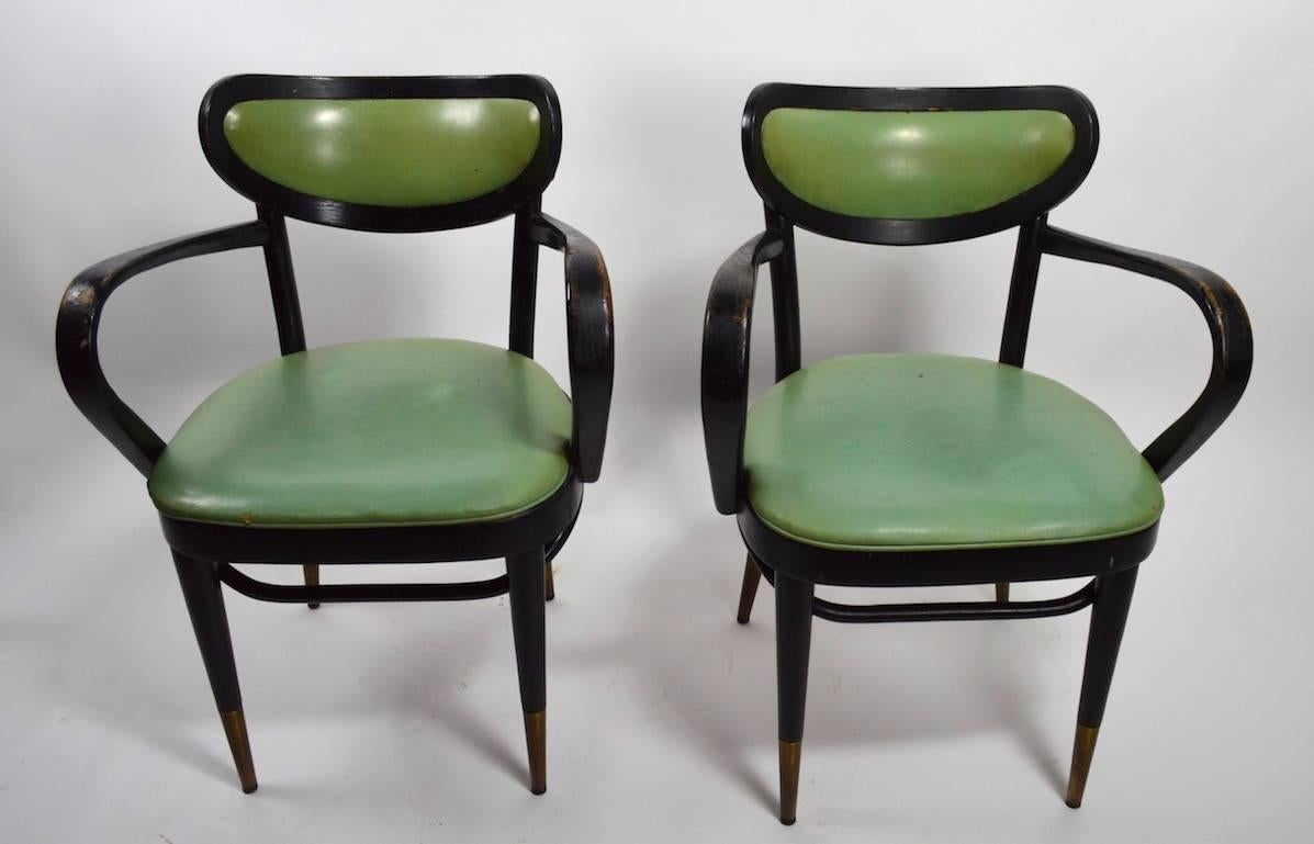 Nice large lot of 15 chairs, perfect for a restaurant, cafe, club, or event. Hard to find intact sets of Mid-Century chairs. Original green vinyl upholstery, later black paint finish (shows wear). Exaggerated curvaceous arm, oblong back, and tapered