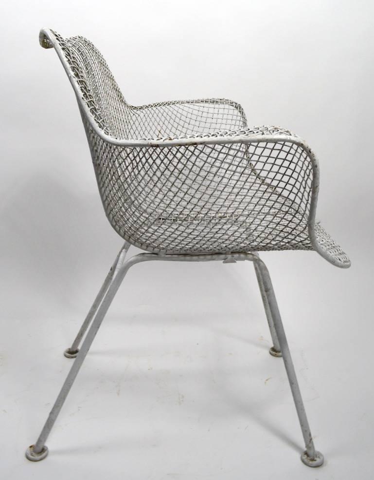 Four Woodard sculptura patio, garden dining height chairs. Metal mesh body rests on wrought iron legs. Arm height 26