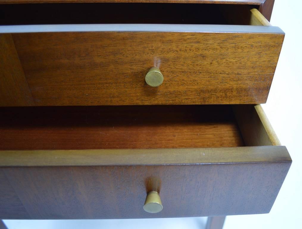 Pair two-drawer nightstands, of chest on stand form. Originally designed as nightstands, these tables will also work as end, or lamp tables. The stands have been professionally refinished and are in perfect, ready to use condition.
Mahogany and