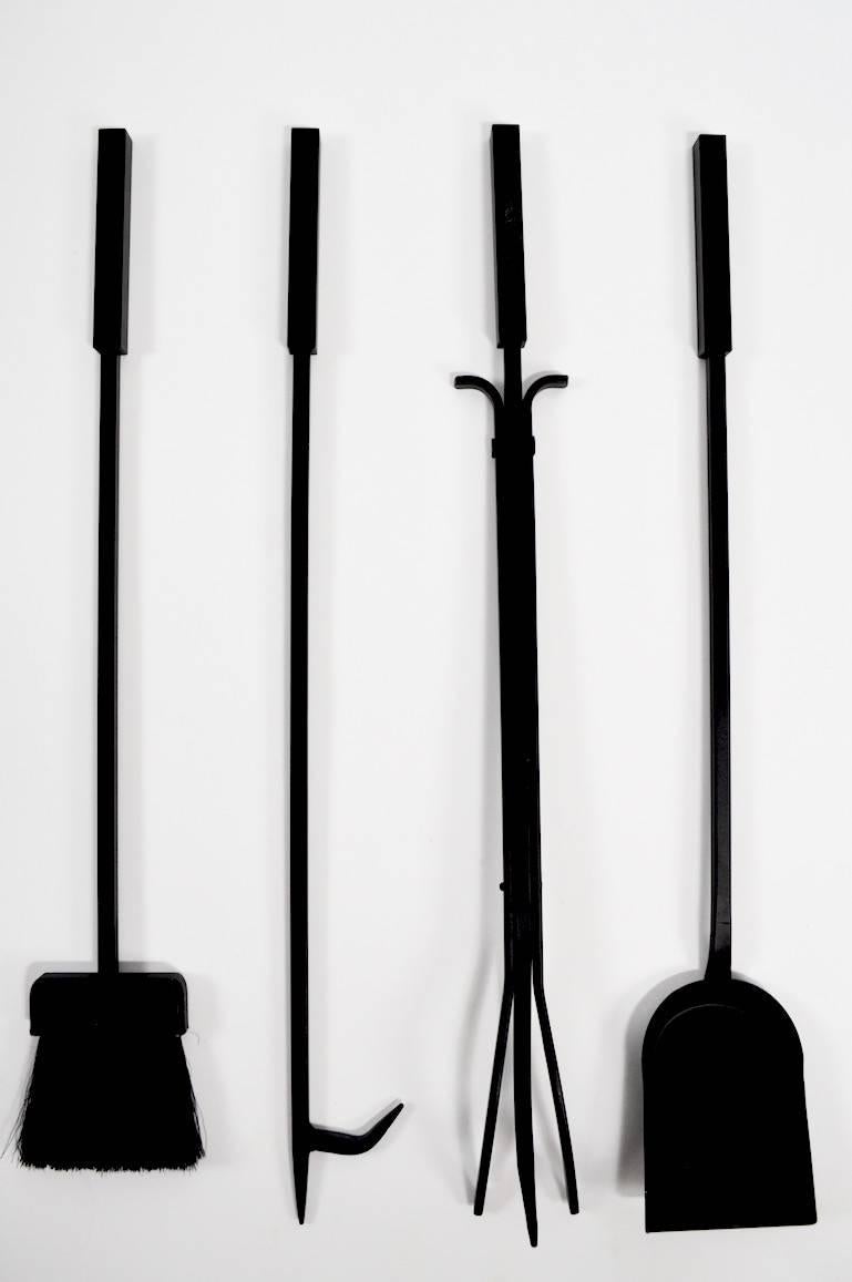 Interesting modernist tool set in black finish. Four tools hang from center stand.
 