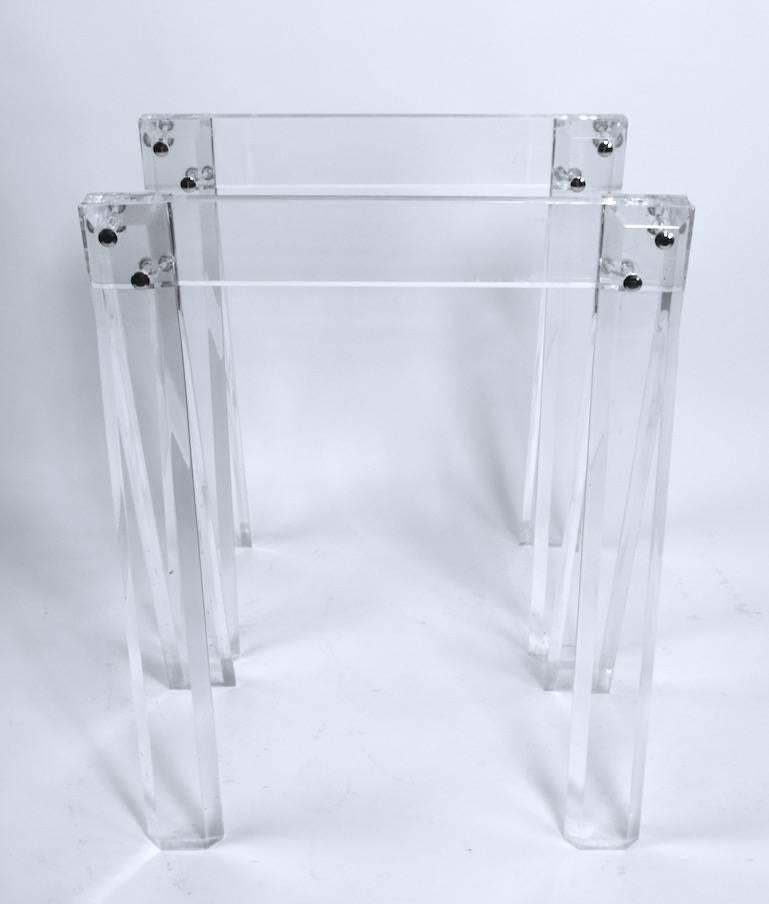 Great pair of solid Lucite sawhorse form table bases. These bases are perfect to support a glass top, they are dining or desk height. They are sturdy, stabile and substantial enough to support a large and thick top, making customizing possible.