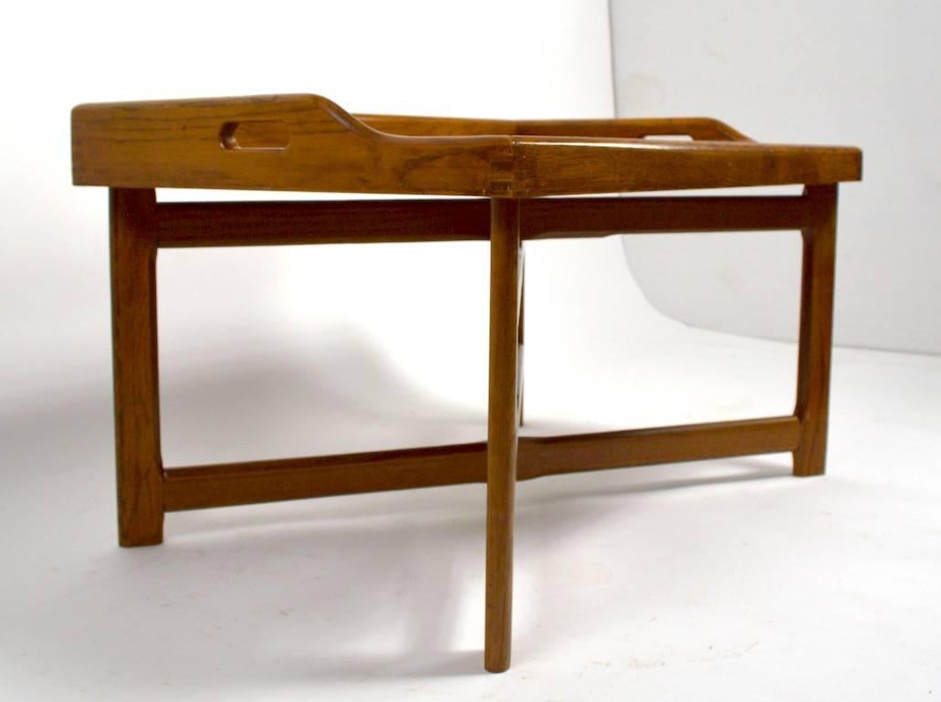 Nicely constructed oak tray top table with folding X-form base. Classic Campaign furniture style, with removable handles top and collapsable base. 
 Possibly made by Jamestown furniture company, but unmarked.