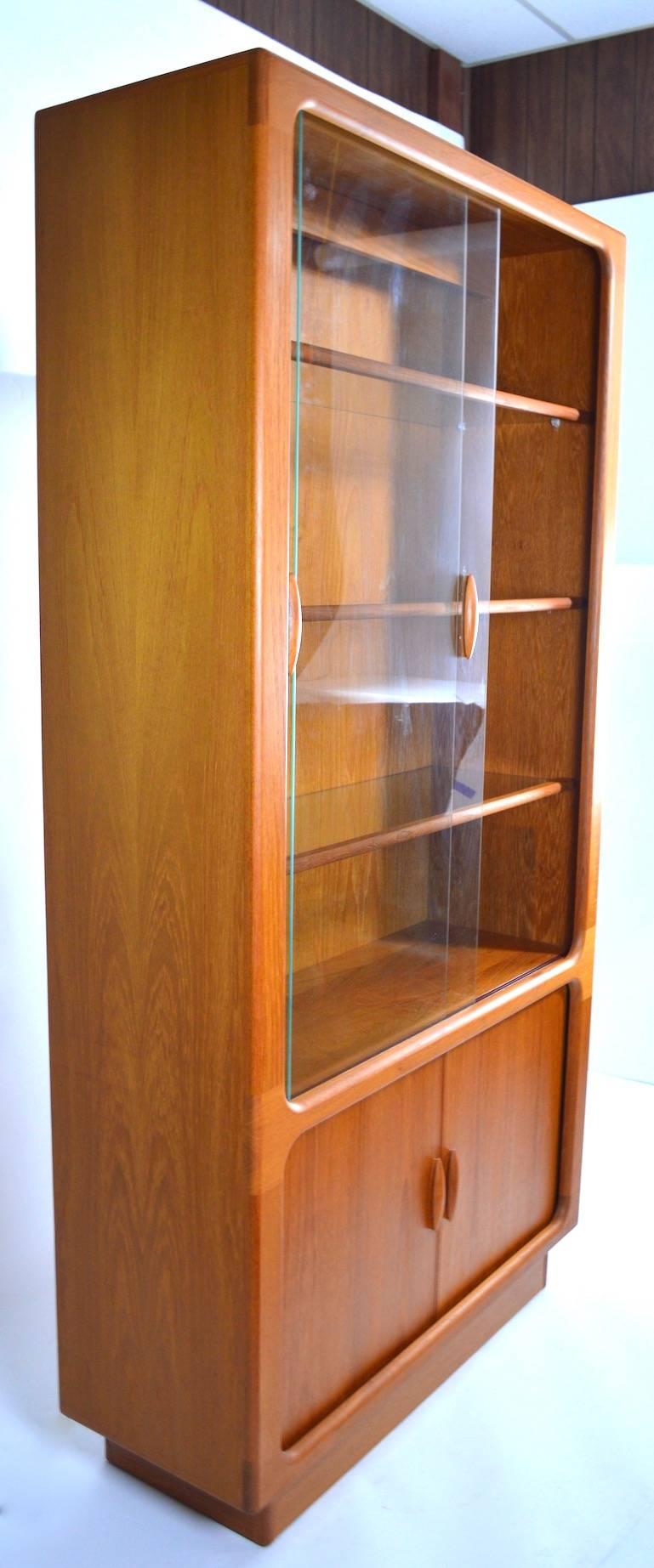 Dyrlund china cabinet, vitrine, with tambour roll doors at base, sliding glass doors, and adjustable wood trim glass shelves. This great display case features an interior light to highlight the items on the shelves. Great original condition, clean,