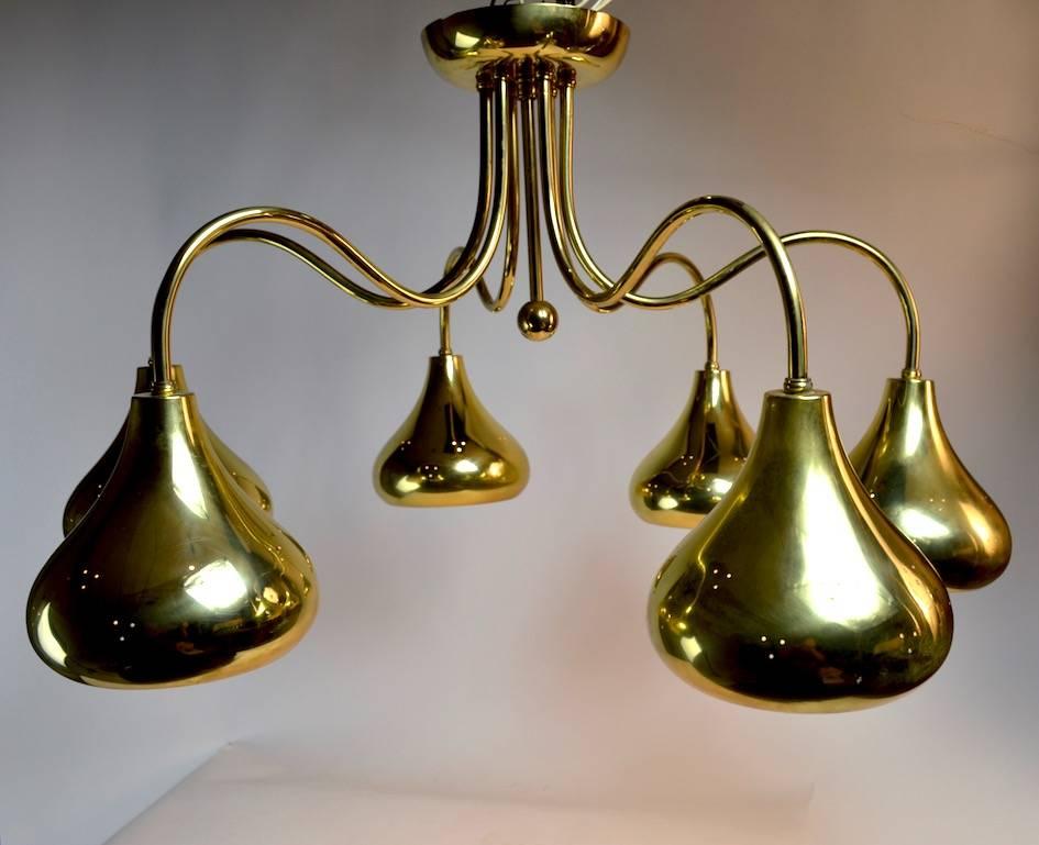 Brass six-light fixture by Lightolier, attributed to Paavo Tynell. Each down facing shade is perforated to add to the decorative presence and total light output. Wonderful scale and condition, clean, original, ready to install. Each shade 6