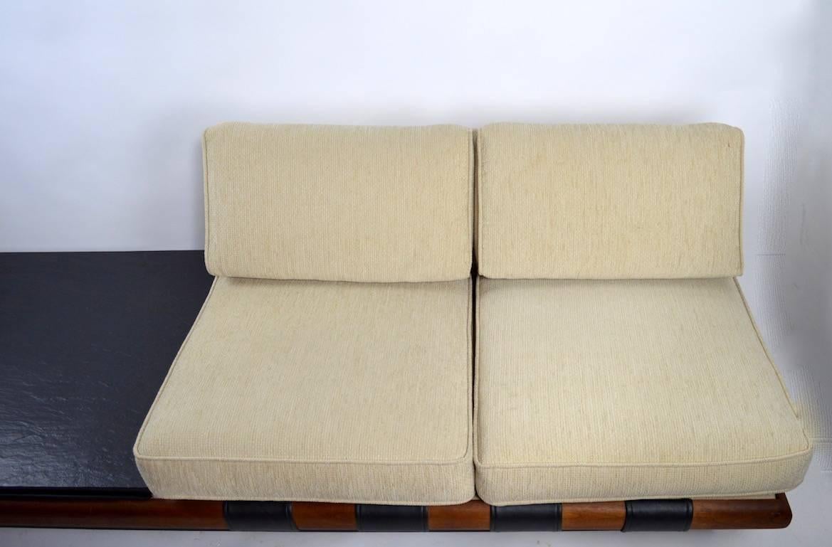 Stylish two-seat sofa with attached side table designed by Adrian Pearsall for Craft Associates. Clean, original condition, ready to use. Please view the matching three seat version we have listed, from the same estate.