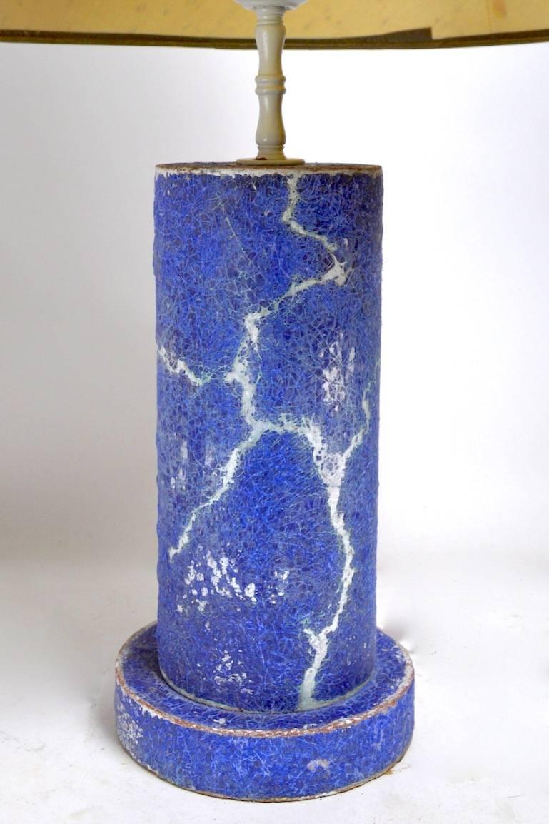Nice cylindrical pottery lamp attributed to Bouck White, blue crackle over grey, pink pottery ground. Working, original condition, metal fitments in later white paint finish, paper shade not included.