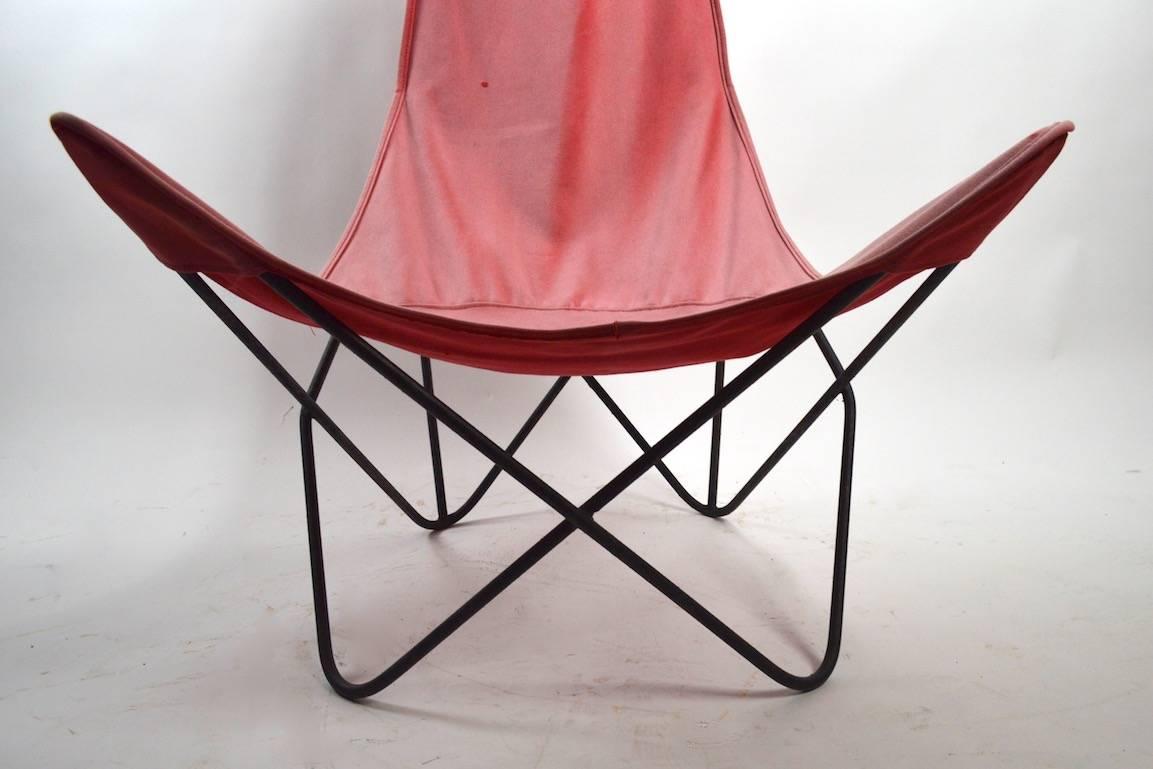 Not often found form, Butterfly Sling Chair with exaggerated tall back. This example comes with the original canvas sling seat. Canvas seat is usable as is however it shows wear and signs of use.