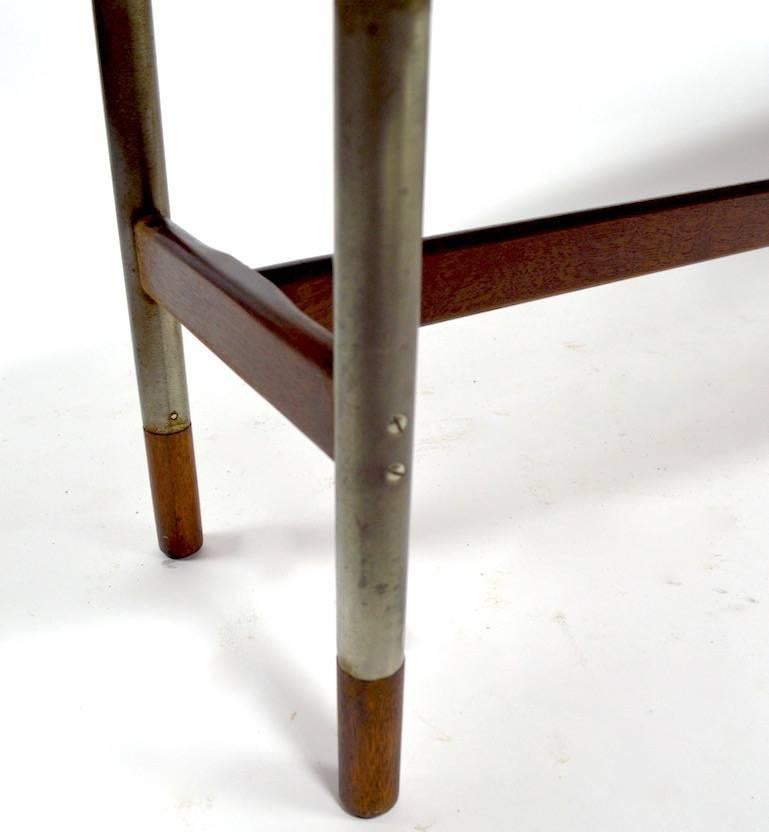 Oval top on stainless legs with teak feet. This model is often attributed to Arne Vodder, for Sibast as he designed a similar line. We believe this is a Vodder design, however cannot document the form.