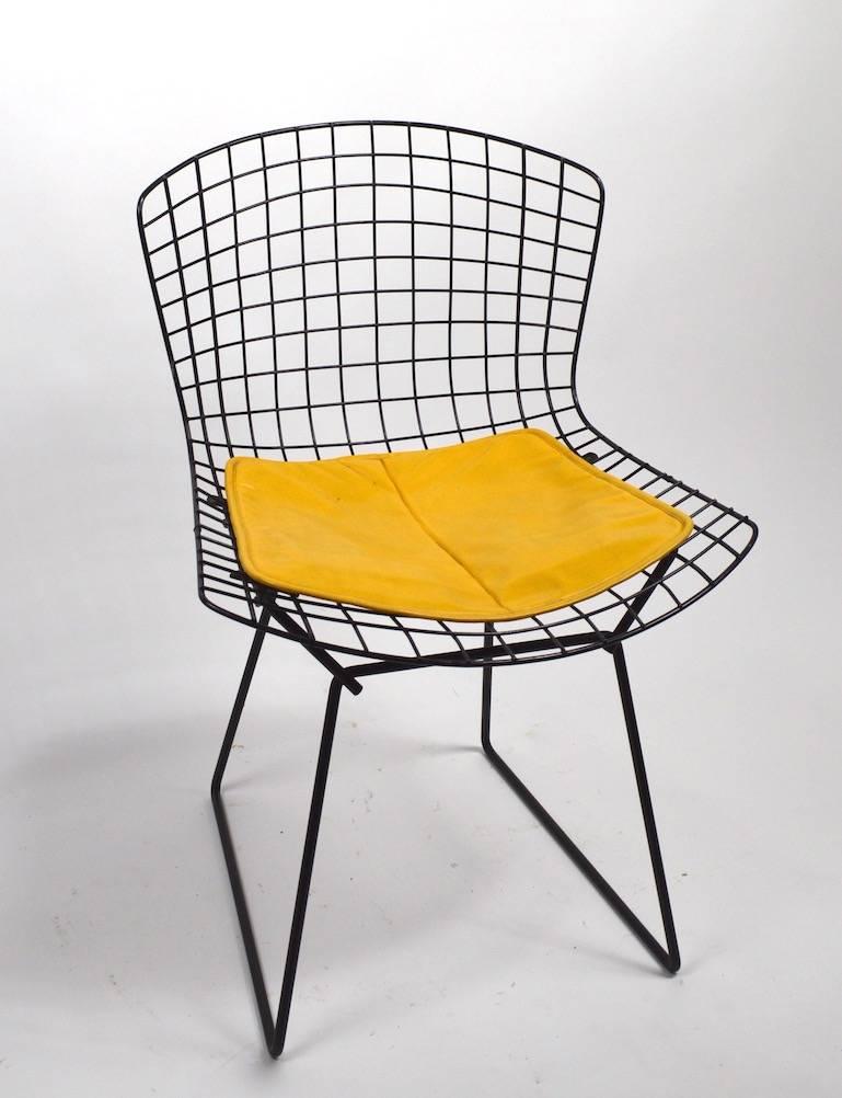 Nice pair of Bertoia design for Knoll wire side chairs in black with original yellow pad seats. Clean, original, ready ton use.