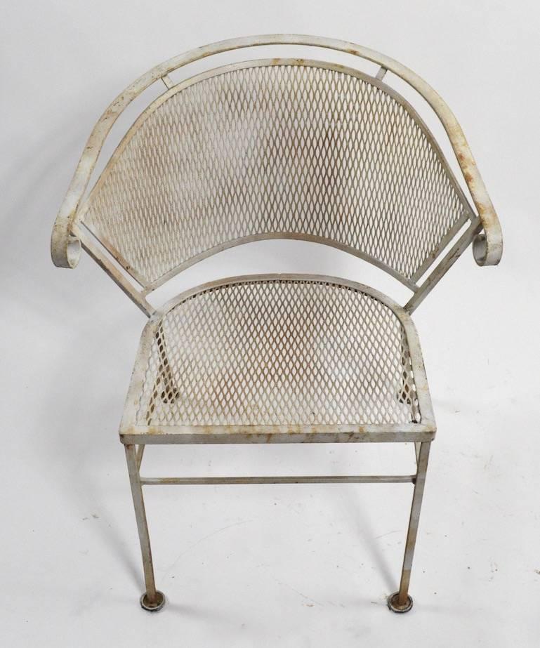 Six metal mesh and iron dining chairs by Woodard. These chairs show some surface rust and general wear to the finish, we can provide custom powder coating, if you prefer a new finish, or they can be used as is. Priced as a set 