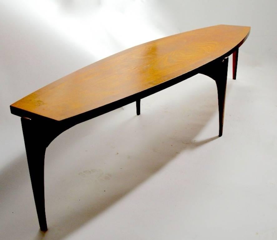 Surfboard form coffee table with bookmatched veneer probably by Henredon.