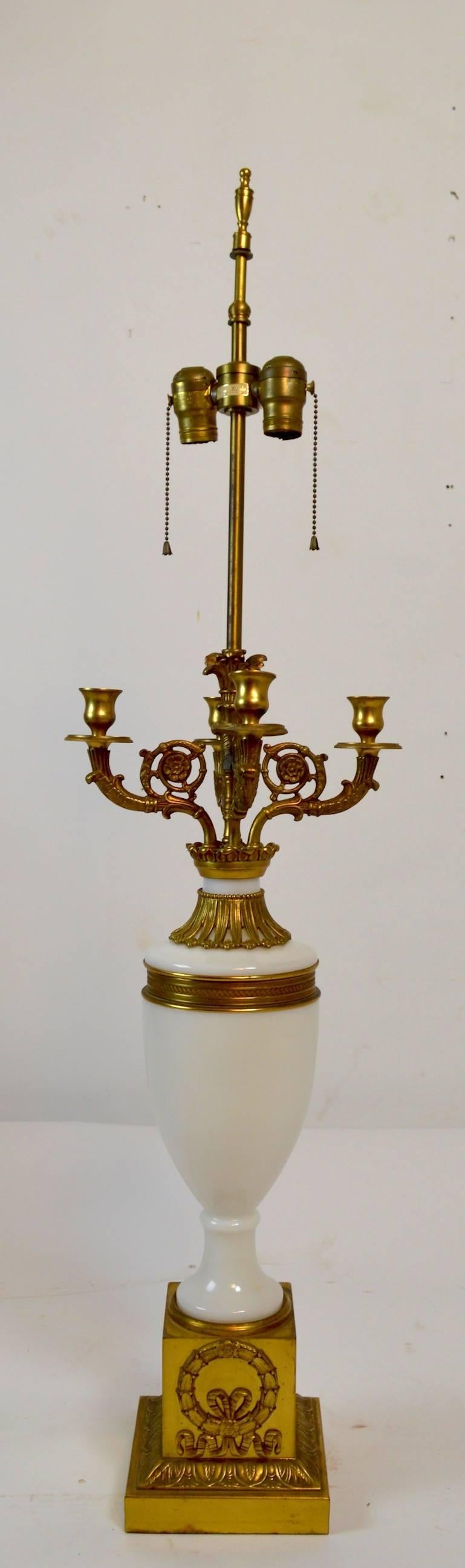 Pair of Classic Revival lamps by Warren Kessler, each having brass candelabra tops, brass mounts, and base. Both are in very fine, original, and working condition.