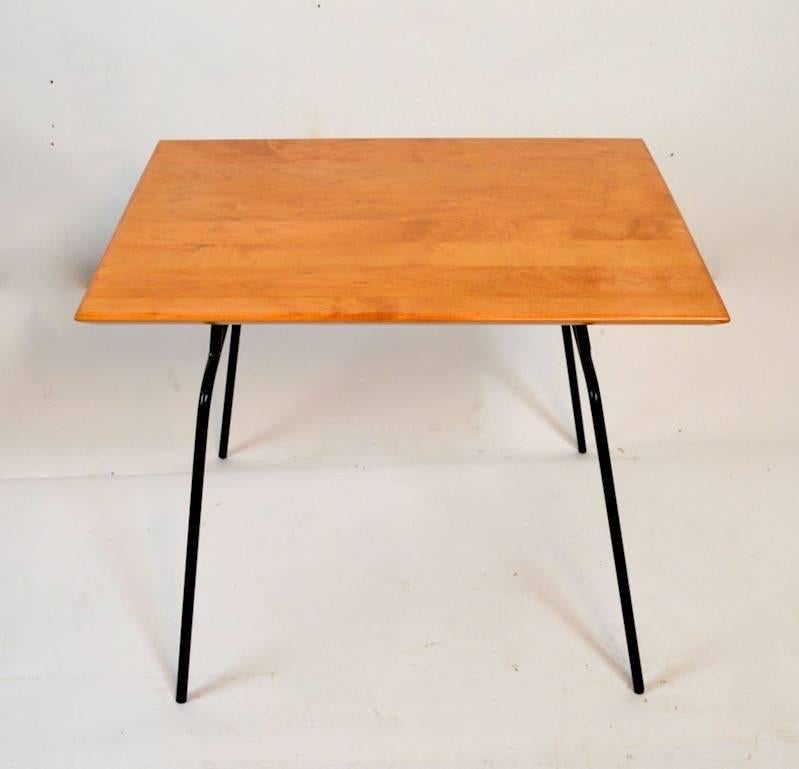 Maple top on solid iron rod legs, the top has been recently refinish, the table is extra clean and ready to use. Classic architectural Mid Century Modern School applied design, signed Paul McCobb Planer Group for Winchendon.