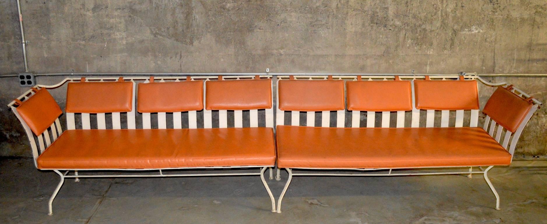 Great extra long two-piece sectional sofa attributed to the Woodard Furniture Company. This sophisticated even arm sofa has metal strapping as the seat and back support, on a metal superstructure, The cushions are orange vinyl, which are useable as