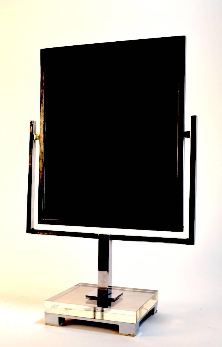 Two sided mirror on bright chrome easel, mounted on Lucite and chrome base. This mirror was designed by CHJ in the 1970s, the mirror itself is 12
