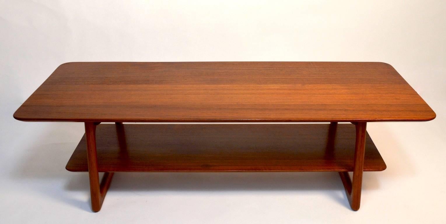 Danish modern teak coffee table attributed to Børge Mogensen. Two tiers. Lower shelf rests on brass peg hardware.