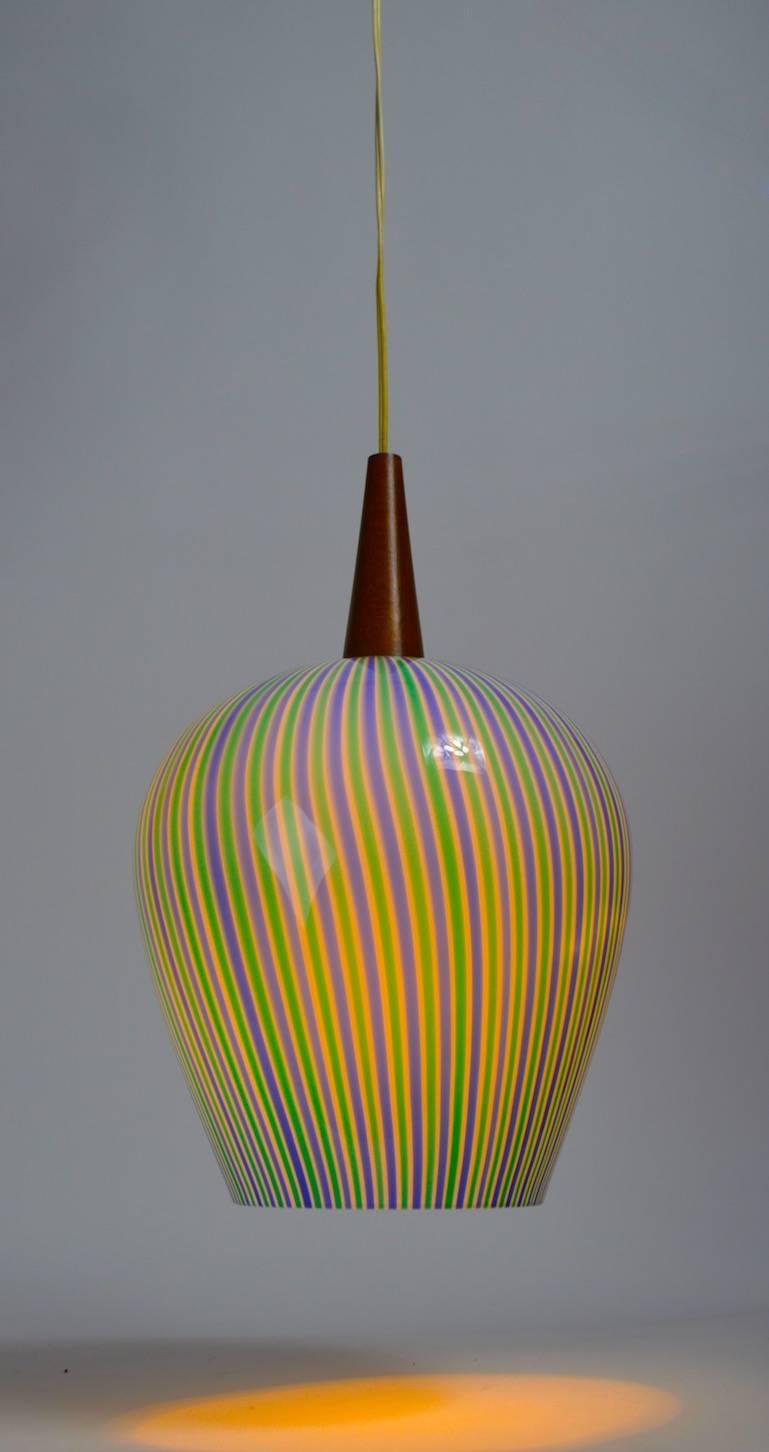 Striped glass pendant shade with teak mount probably Swedish in origin. Blue and green alternating stripes with white cased glass interior. Measure: Comes with approximately 50