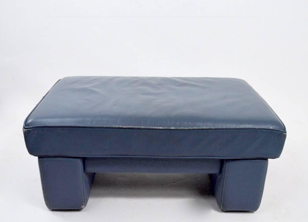 Geryish blue leather ottoman designed by Walter Knoll for Brayton International. Great for use as an ottoman, footrest or small bench. Shown with original chair (chairs and sofa listed separately). Ottoman shows minor wear normal and consistent with