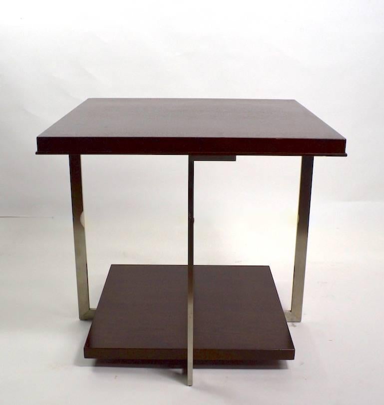 Square two tier table with solid stock metal frame, and solid wood shelves. This table is extremely well constructed, and in very good overall condition, showing some Minot=r cosmetic wear to wood surfaces, normal and consistent with age.
Troscan