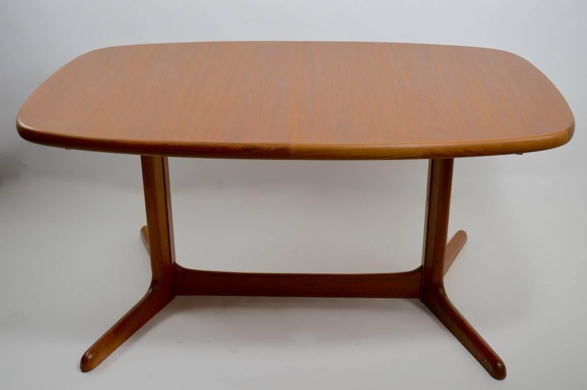 Clean, original, ready to use oval Danish dining table, with two (19.75 inch) leaves. Table retains original Rasmus made in Denmark (designed by N.O. Moller for Gudme Mobilfabrik). Classic Danish form, and expected Danish quality - one extremely