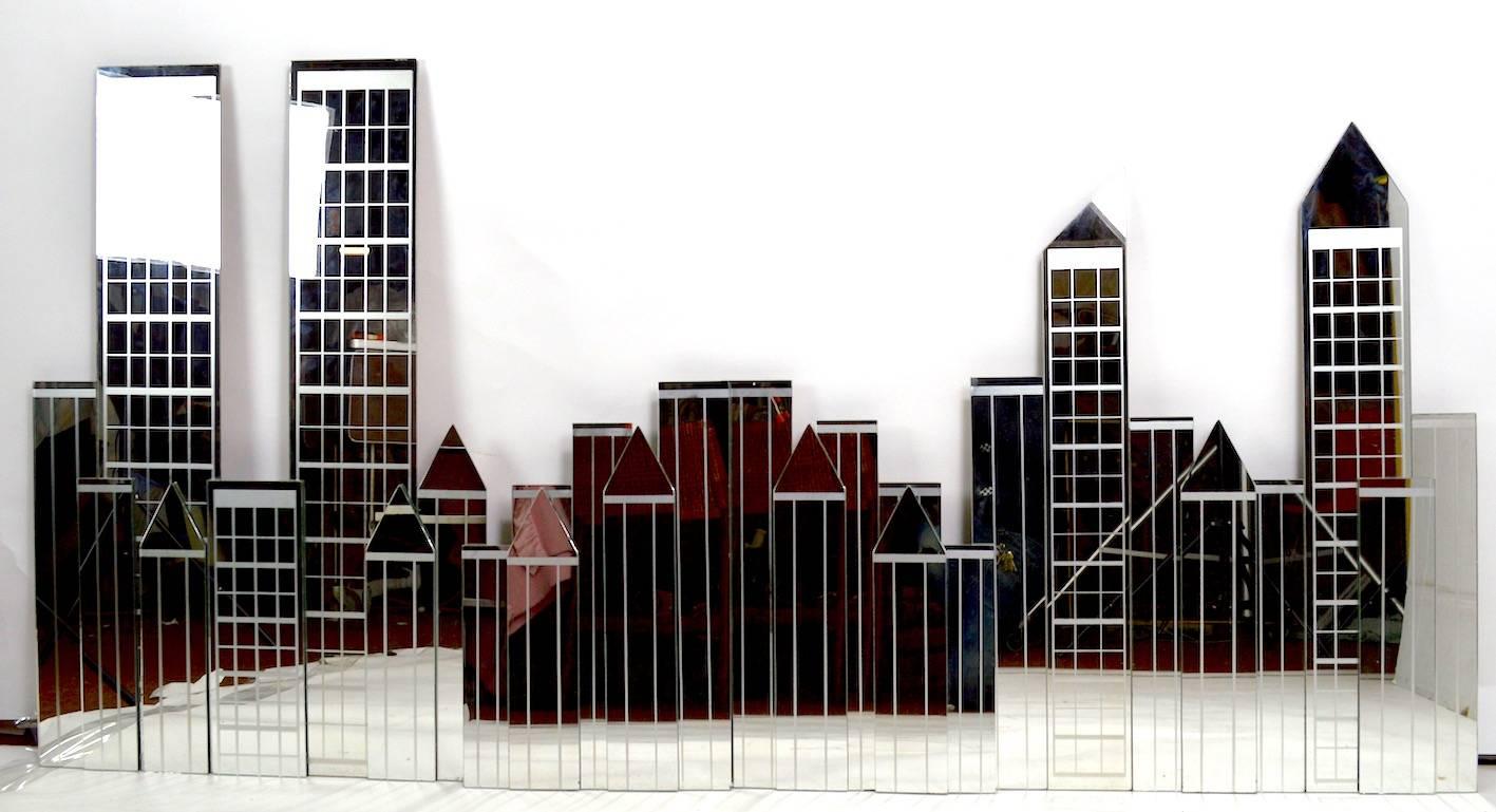 Manhattan skyline by Mechanical Mirror Works Inc. This wall mount sculpture consists of four panels, depicting NYC pre 9 -11, which assemble into one long decorative item. The piece shows minor edge chips, minor and consistent with age.
     