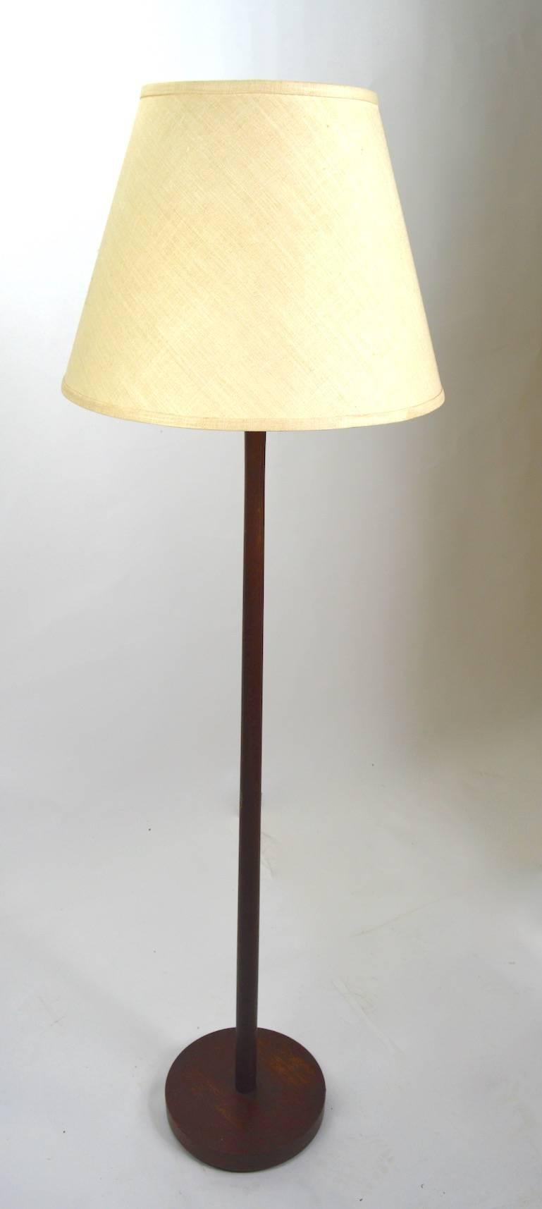 Wood pole lamps with original shades, by the Laurel Lamp Company. Elegant sophisticated form, original and working condition, hard tone find in pairs.
Measures: Shades 16.25 inch diameter at bottom.
 