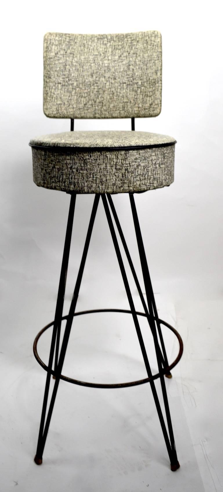 Four 1950s stools, can be used with or without backrests, as shown. Measures: Seat height 29 inches. Vinyl upholstery, with wrought iron hairpin legs. Offered and sold as a set of four.