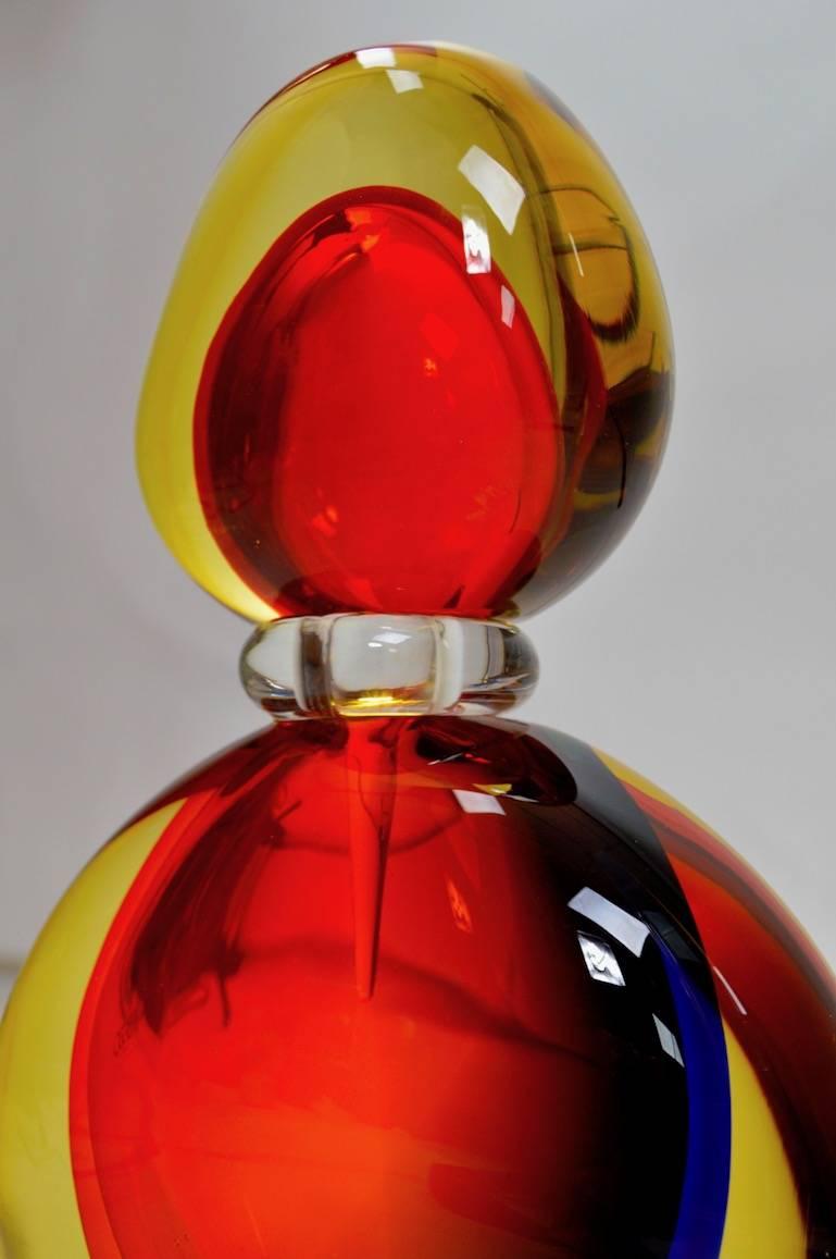 Oversized Murano Sommerso perfume bottle by Luigi Onesto for Oggetti. This example has three colors, red, blue and yellow, it is in perfect condition, and retains the decal, as well as signature on the base.