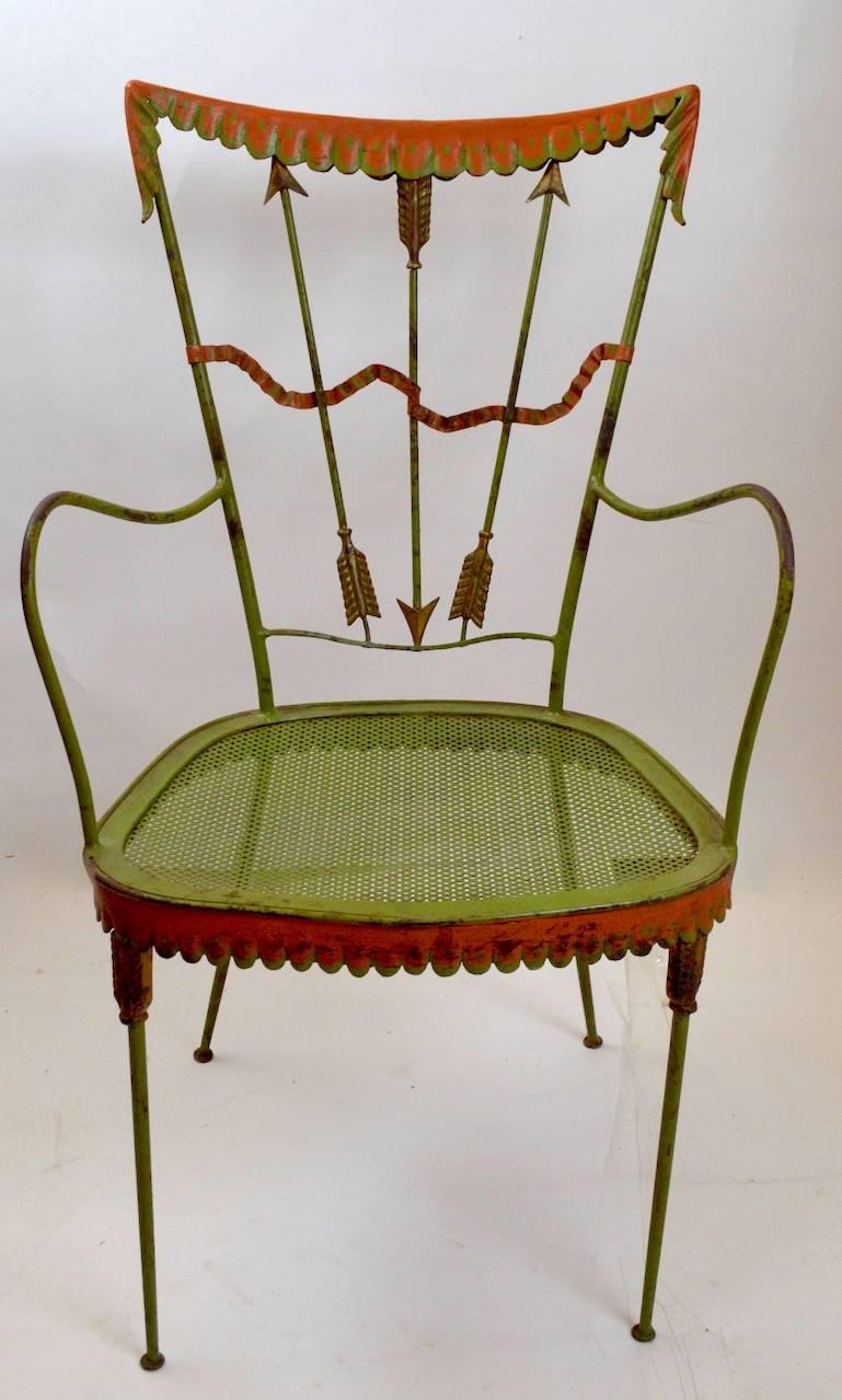 Rare armchair version of the classic wrought iron garden chairs by Tomaso Buzzi. Measure: Arm height 24.75 inches, seat height 15.5 inches. Original paint finish, shows some cosmetic wear, normal and consistent with age. Offered and priced as a pair.