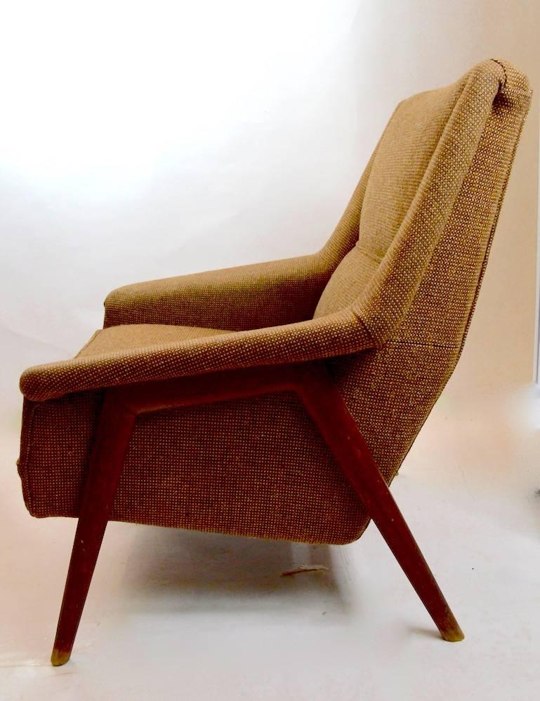 Classic Danish Modern lounge chair designed by Folke Ohlssen for DUX. This example shows some cosmetic wear to both e fabric, and the finish on the exposed teak wood frame, as shown. The chair is usable as is, or can be restored to taste if you