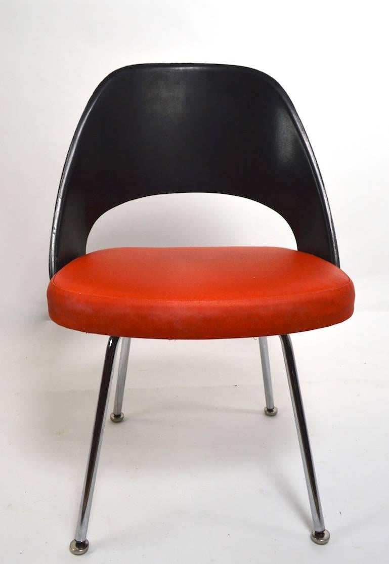 Saarinen designed chairs for Knoll. These are the early version of this chair, having fiberglass backrest. Both chairs show some cosmetic wear, and loss along the edges of the backrest. Measures: Seat height 18 inches. Priced and offered