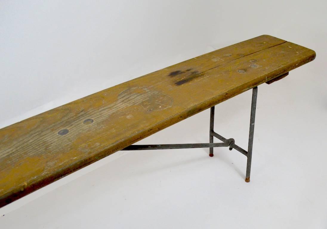 Weathered pine top supported by hand wrought  metal folding legs. Circa 1930's Naval issue in great original patina. 