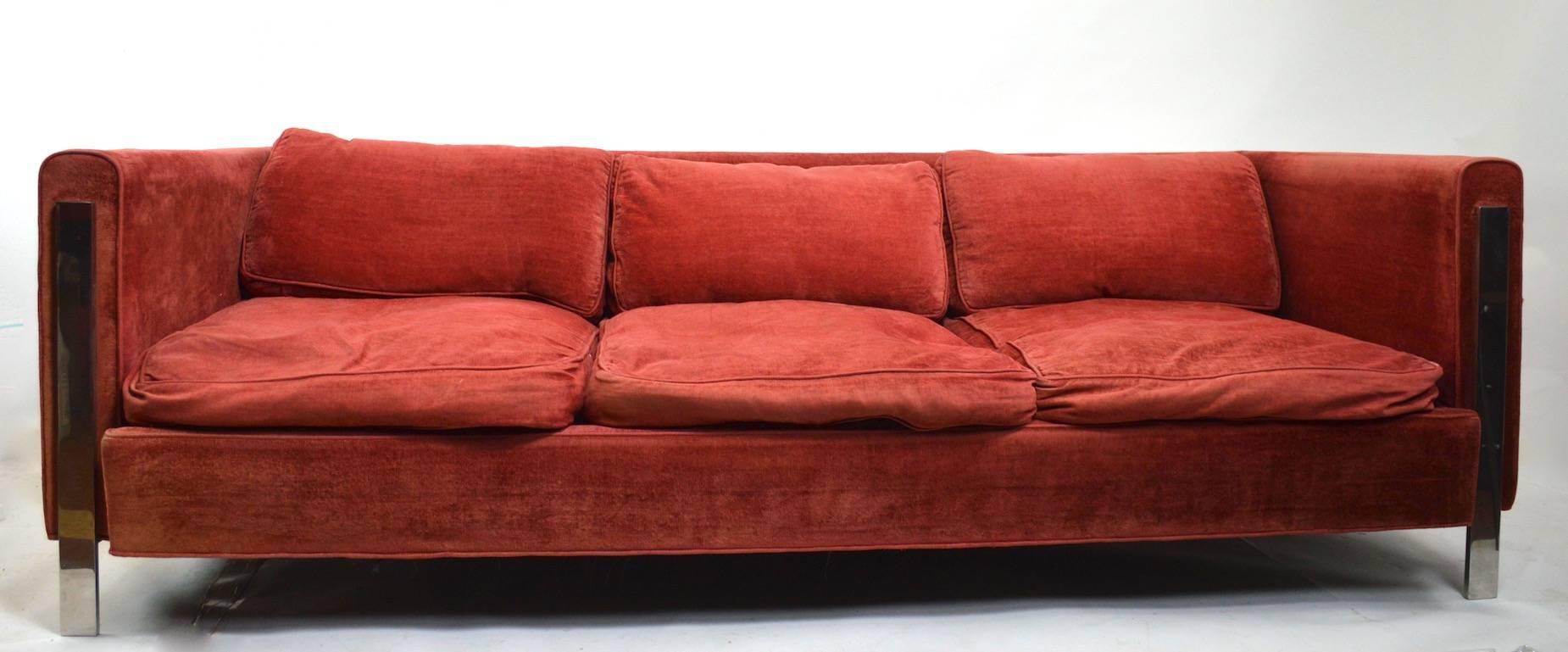 Even arm box sofa in original velvet blend upholstery (fabric shows wear), down cushions and bright chrome legs. Classic 1970s form attributed to Milo Baughman. Usable as is if you like the broken in look, or reupholster to your requirements if you