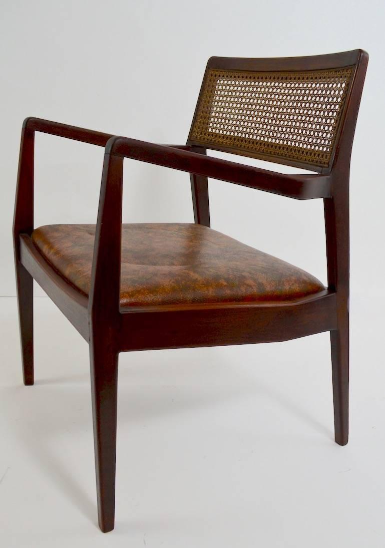 Walnut frames, caned backrests, and vinyl upholstered seats. This set consists of two arm chairs and four side chairs. The frames show some old repairs however are sturdy, solid and ready to use.
Armchair dimensions as follows:
Measures: Total H