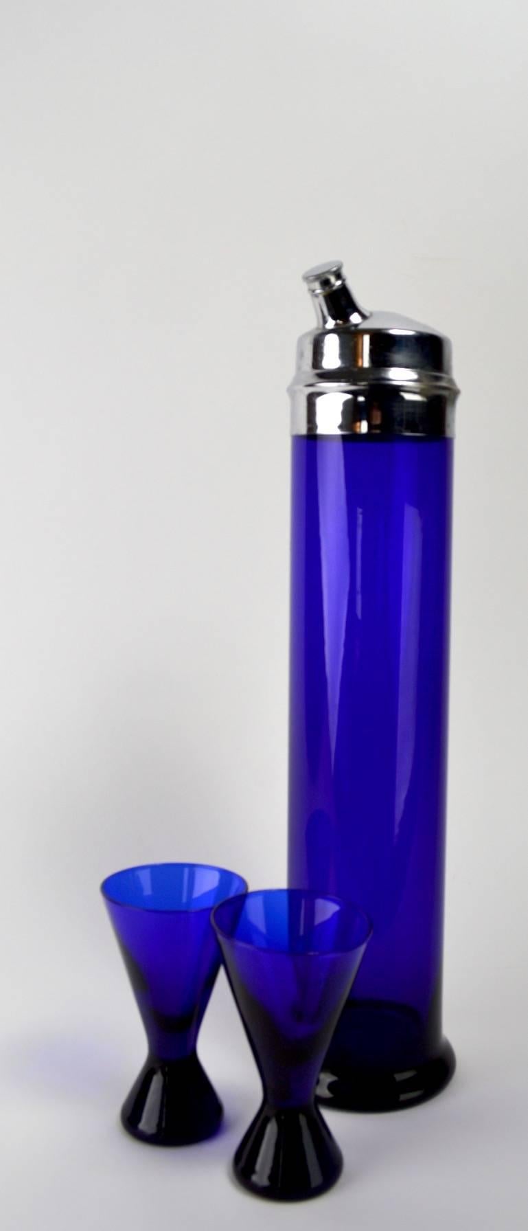 Rare extra tall cobalt blue glass cocktail shaker (16 H) with two original glasses each 4.75 H x 2.75 diameter. Pure Art Deco style, stunning deep color, ready to use condition.