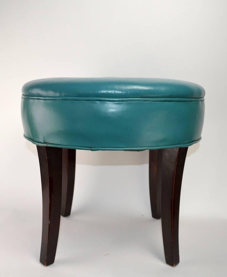 Chic style vanity stool, with original upholstery still intact. Turquoise leather pouf with solid wood splayed legs. Upholstered top 5 inched thick with button detail.