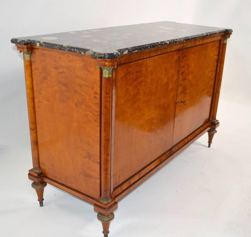 Stylish Directoire style cabinet in satinwood, with marble top. Two doors open to reveal shelved storage. The doors do not close to flush, but will stay closed when cabinet is locked, as shown. Marble top .75 thick.