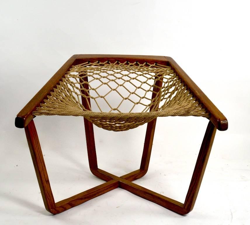Rope net sling forms the seat with exposed oak frame support. Classic architectural midcentury design and execution, great original ready to use condition. Measures: Seat H 19 inches.
