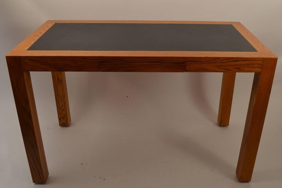 Nice quality  oak Parsons desk with pencil drawer, and black top writing surface. Desk is marked illegibly.