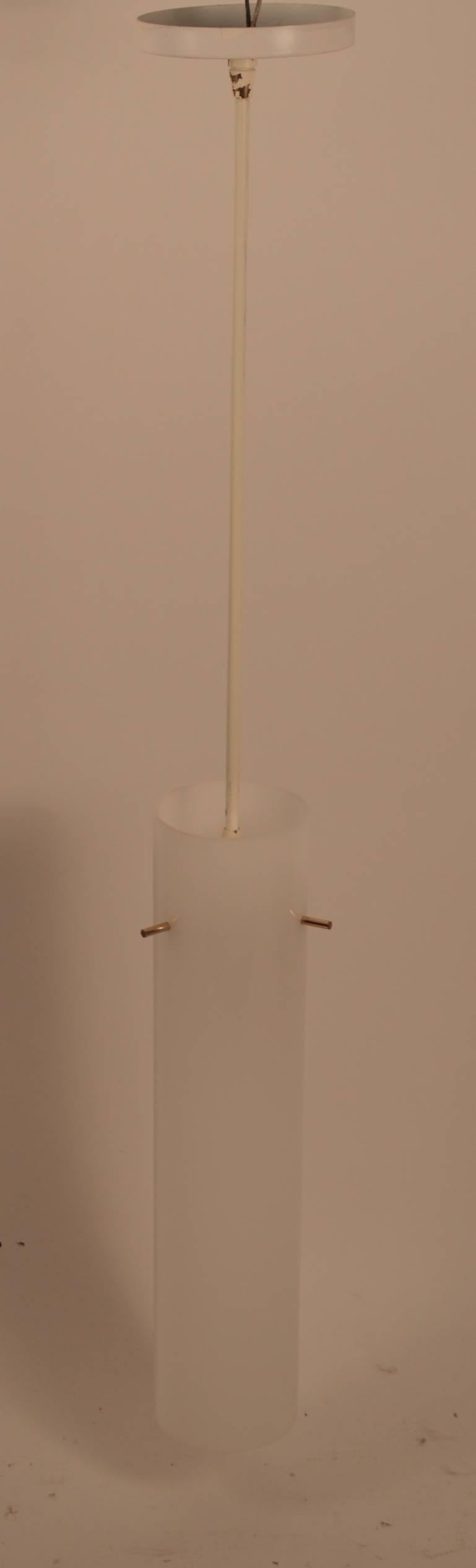 Pair of tubular plastic hanging fixtures. Each fixture has  three brass elements  which support the white shade, which hangs from a vertical  painted white ( original paint  finish ) brass tube, original canopies included.  Modernist  Minimalist 