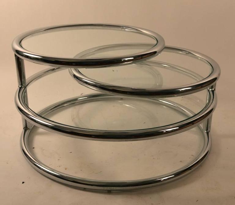 Three round  glass surfaced platforms mounted in chrome rings. The smaller two ( 22