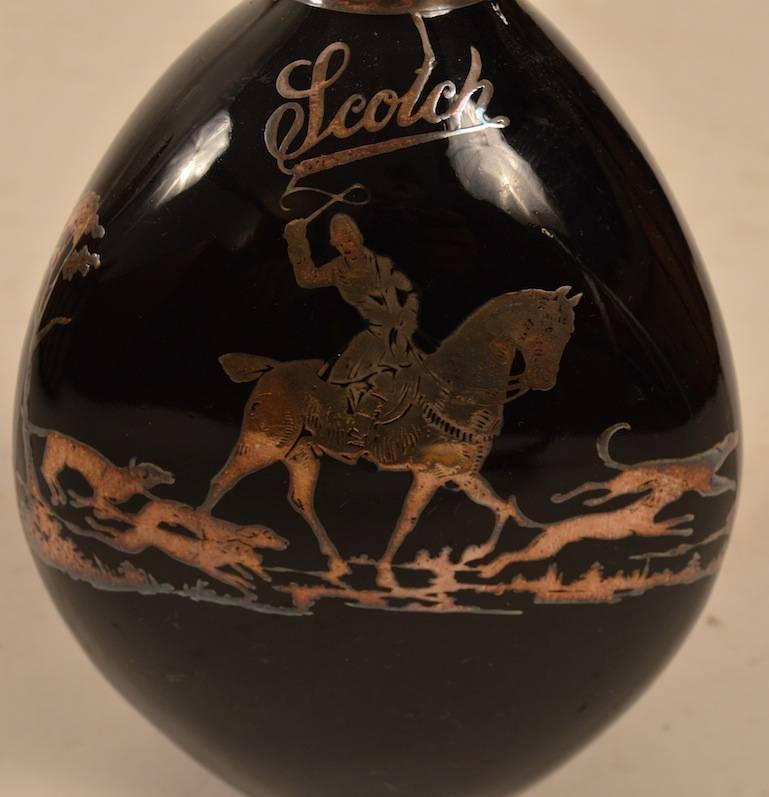 Black glass pinch form  bottle with hunt scene in silver overlay. Perfect condition.