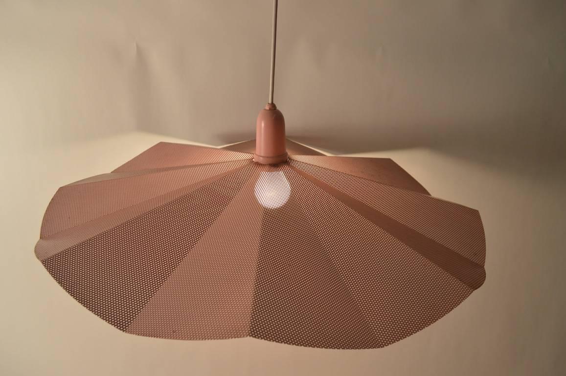 Interesting architectural form, perforated metal shade by Fredrick Raymond, after Mathieu Mategot. The circular shade hangs from a white rubberized cord, original pink canopy included. 