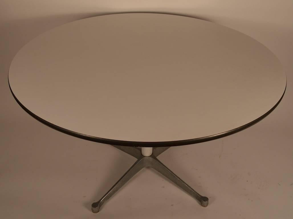 Classic Herman Miller round top dining table with white pedestal, and aluminum  star base. Nice early example, shows some cosmetic wear, normal and consistent with age.