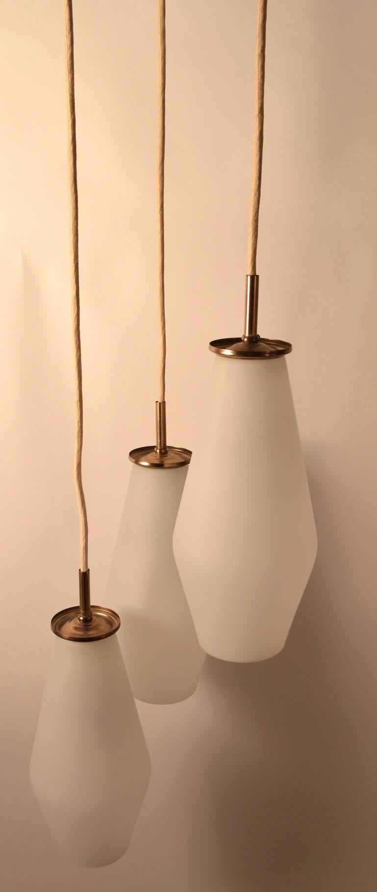  Three frosted white glass globes, brass fitments, woven cords with brass armature and original canopy. Each independent globe can accommodate  up to 100W, however I recommend 60W each. Total drop currently 80