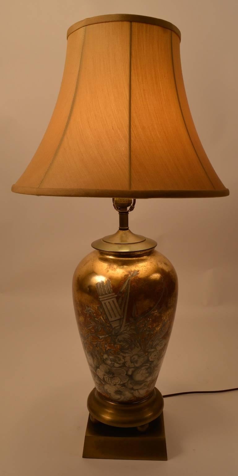 Wonderful pair of eglomise table lamps, probably American in the French Style. Both are in fine, original, working condition. Diameter of lamp body 8.5