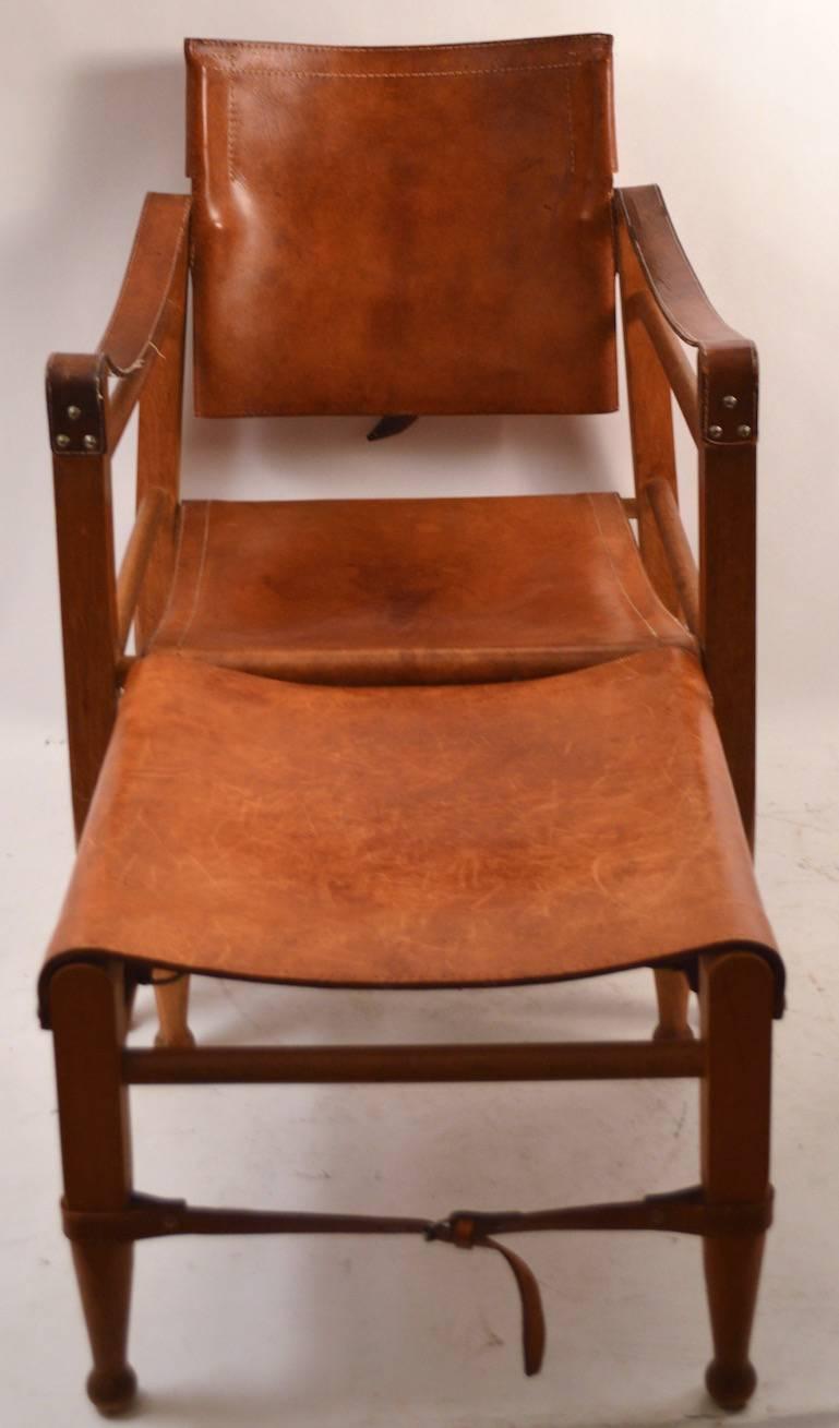 Tilt back chair in original  cognac  leather, comes with the hard to find  original matching foot rest. Design attributed to Arne Norell, period Mid Century example.
Footrest 17.5